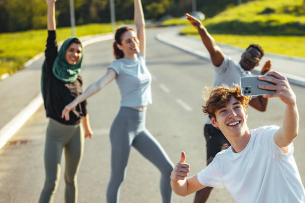 istock Millennial friends on a hiking trip celebrate while posing for photos 1395531900