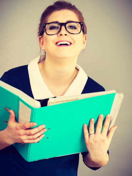 istock Happy positive business woman holding binder with documents 1395534134
