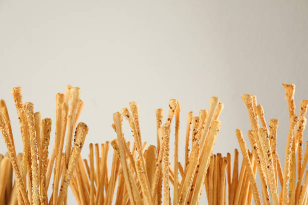 Delicious grissini sticks on light background, closeup