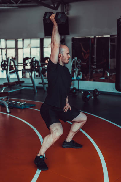 istock Handsome man pulling weight on a track in the gym, stock photo 1395537775