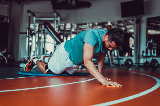 istock Handsome man stretching in gym before workout, stock photo 1395538282