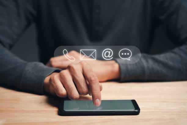 istock Customer support hotline Contact us people connection. Businessman using smartphone with the email, call phone, address, Chat message icons. 1395539763