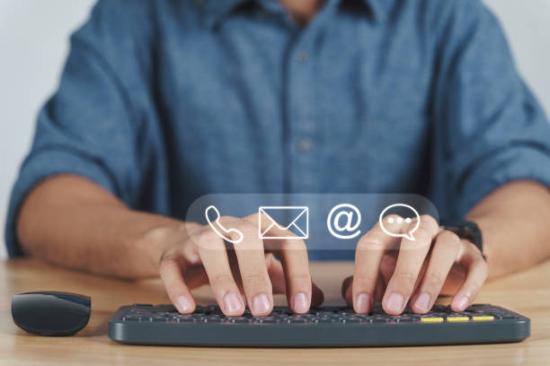 istock Customer support hotline Contact us people connection. Businessman using computer keyboard with the email, call phone, address, Chat message icons. 1395539770