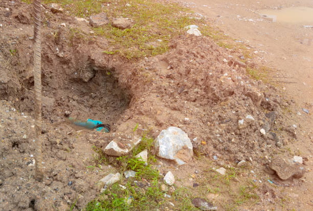 istock plumbing broken plastic pipe in the hole and water in wait repair 1395540551