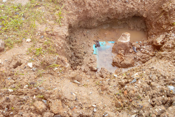 istock plumbing broken plastic pipe in the hole and water in wait repair 1395540586