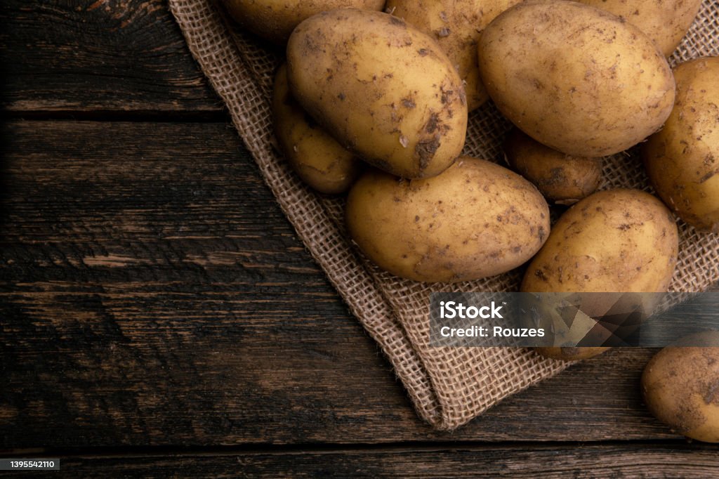 Raw potato on wooden background Raw potato with copy space Raw Potato Stock Photo