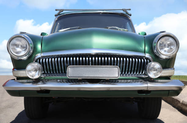 Beautiful green retro car on street, low angle view
