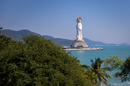 The sculpture of Guan Yin of the southern sea in Nanshan Cultural Tourism Zone in Sanya, Hainan, China, blue sky, copy space for text, wallpaper, background