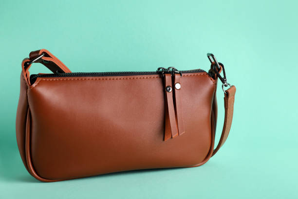 istock Stylish brown woman's bag on turquoise background 1395543289