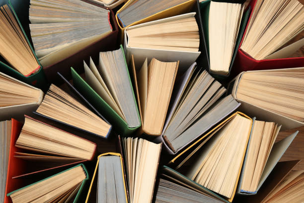 istock Many hardcover books as background, top view. Library material 1395543540