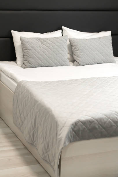 istock Comfortable hotel bed with soft pillow and bedding 1395543656