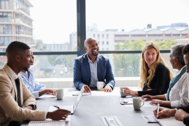 istock Manager laughing during a meeting with his diverse team 1395544769