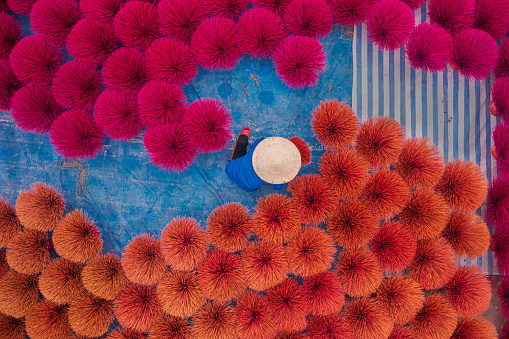 Drone view of a worker is drying incense sticks - a traditional incense of Vietnam - Cau Bau market, Thanh Oai, Ha Noi, North Vietnam