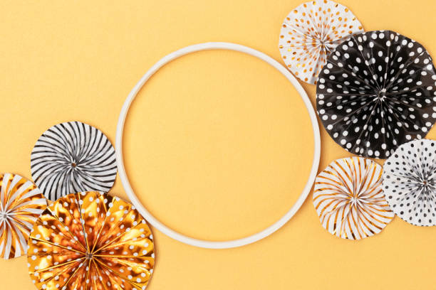 istock Empty round frame and paper fans on a golden background. 1395547950