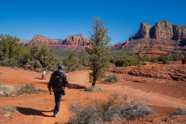istock Man on spring hiking trip in red mountains. 1395548972