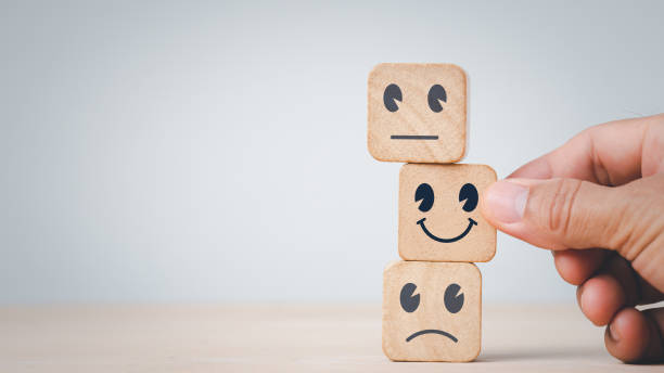 istock Customer services best excellent business rating experience. Satisfaction survey concept.Chooses a smile face on wood block cube. 1395549644