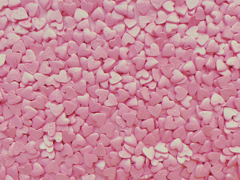 textured background, lots of small decorative candy pink hearts