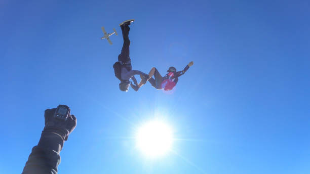 istock Skydivers fall through clear skies, in aerial flight 1395553204