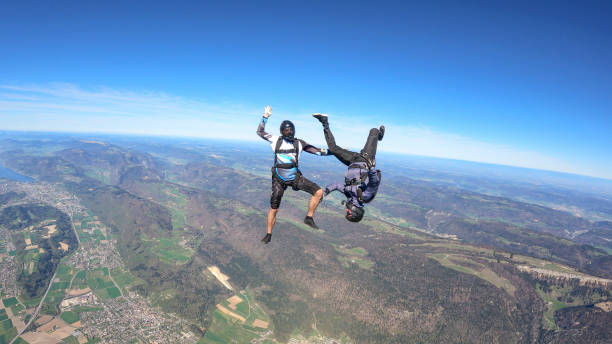 istock Skydivers fall through clear skies, aerial flight 1395553208
