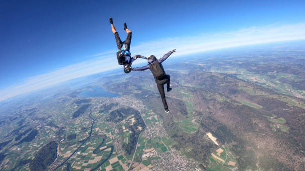 istock Skydivers fall through clear skies, aerial flight 1395553213