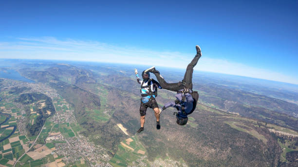 istock Skydivers fall through clear skies, aerial flight 1395553214
