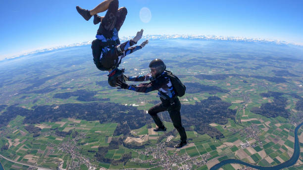istock Skydivers fall through clear skies, aerial flight 1395553373