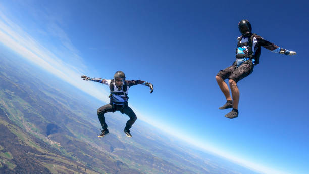 istock Skydivers fall through clear skies, aerial flight 1395553458