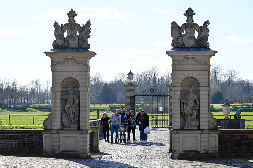 Nordkirchen, Germany, March 18, 2022 - West bridge to Nordkirchen Castle, some unidentified celebrating students in the background.