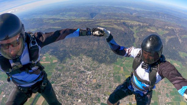 istock Skydivers fall through clear skies, aerial flight 1395553524