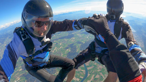 istock Skydivers fall through clear skies, aerial flight 1395553556