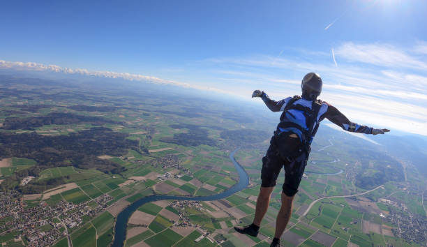 istock Skydiver falls through clear skies, aerial flight 1395553583