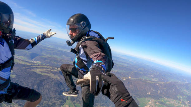 istock Skydivers fall through clear skies, aerial flight 1395553585