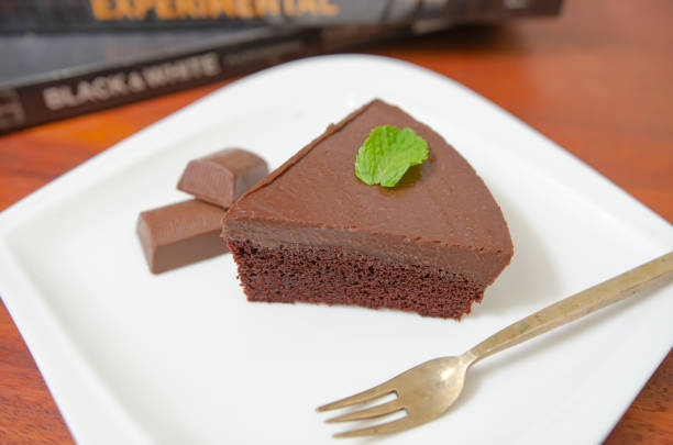 istock Chocolate cake decorated with chocolate sauce on a wooden table. 1395554824