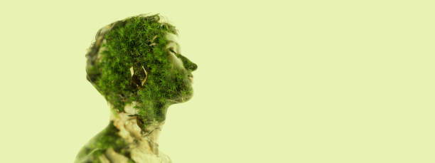 istock Creative image. Profile silhouette of young transparent man and nature, grass landscape isolated over light green background. Flyer 1395554861