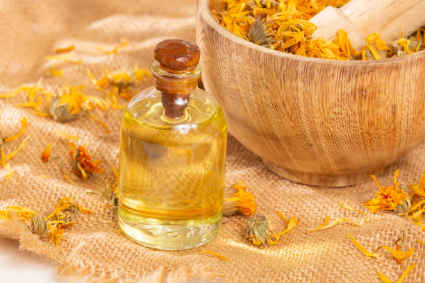 istock Calendula officinalis - Calendula Oil In A Glass Bottle 1395556599