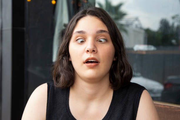 istock Portrait of a female face making a young squint expression 1395558780