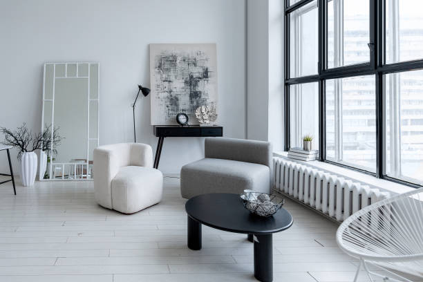 istock modern minimalistic interior design of light bright monochrome room with black and white furniture, clean white walls and huge windows 1395558916
