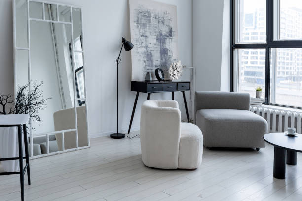 istock modern minimalistic interior design of light bright monochrome room with black and white furniture, clean white walls and huge windows 1395558945