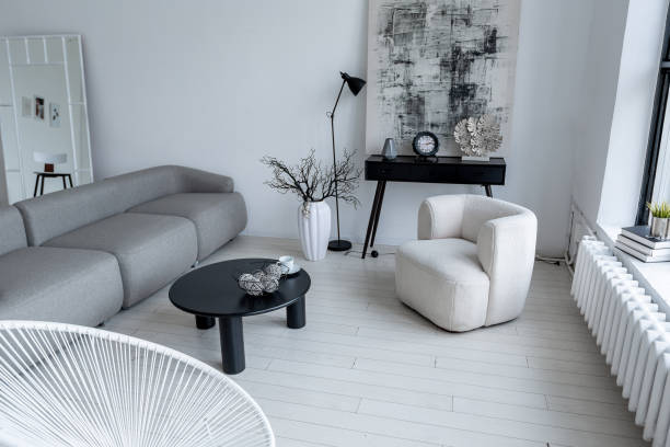 istock modern minimalistic interior design of light bright monochrome room with black and white furniture, clean white walls and huge windows 1395558959