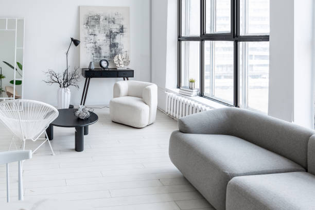 istock modern minimalistic interior design of light bright monochrome room with black and white furniture, clean white walls and huge windows 1395559000