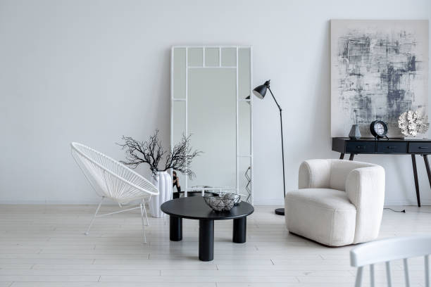 istock modern minimalistic interior design of light bright monochrome room with black and white furniture, clean white walls and huge windows 1395559014