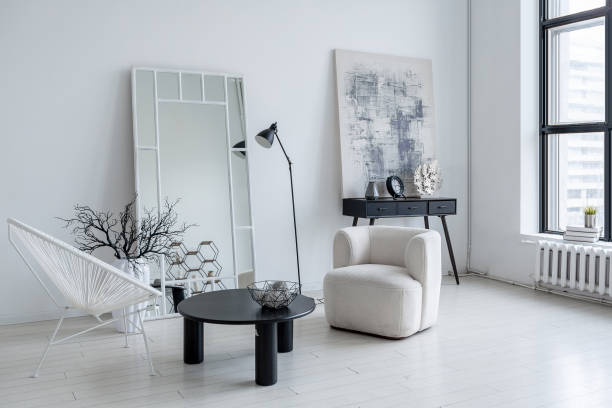 istock modern minimalistic interior design of light bright monochrome room with black and white furniture, clean white walls and huge windows 1395559016