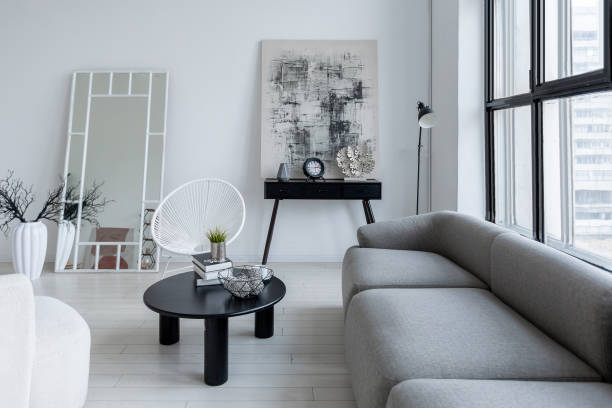 istock modern minimalistic interior design of light bright monochrome room with black and white furniture, clean white walls and huge windows 1395559051