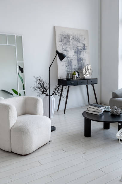 istock modern minimalistic interior design of light bright monochrome room with black and white furniture, clean white walls and huge windows 1395559086