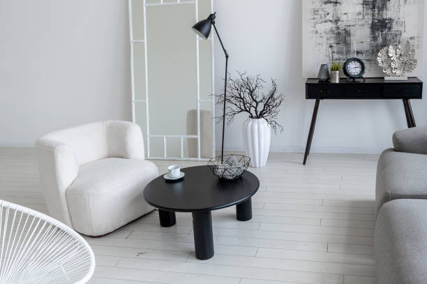 istock modern minimalistic interior design of light bright monochrome room with black and white furniture, clean white walls and huge windows 1395559100