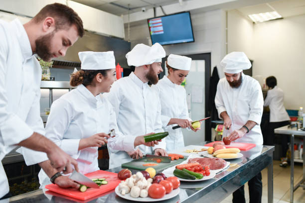 istock Focused Cooks Chopping Fruits And Veggies Before Preparing Them For Stew 1395559233