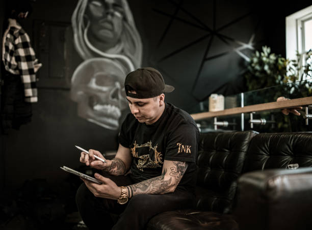 istock Mexican Tattoo artist sketching on digital tablet 1395561112