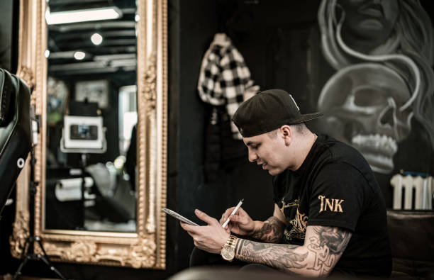 istock Mexican Tattoo artist sketching on digital tablet 1395561140