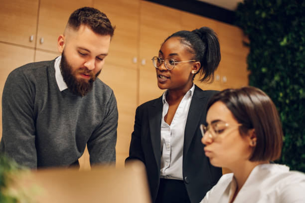 istock Multicultural team working together in office and having a meeting 1395561158