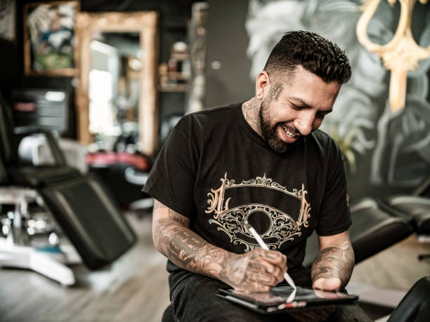 istock Mexican Tattoo artist sketching on digital tablet 1395561163